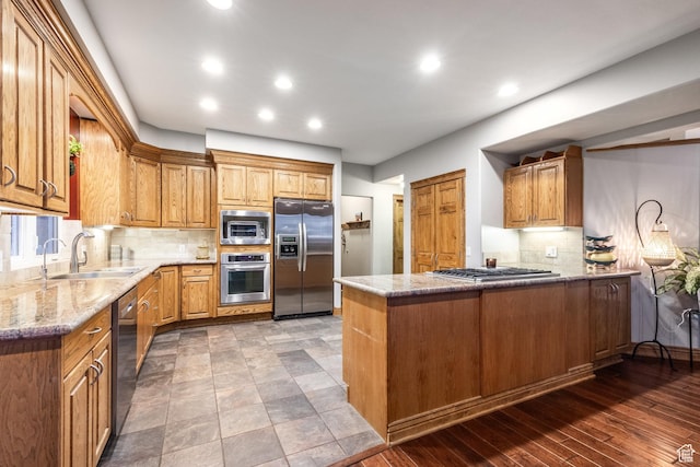 105 Paradise Rd, Summit Park, UT 84098 - kitchen with stainless steel appliances, a sink, a peninsula, light stone countertops, and recessed lighting