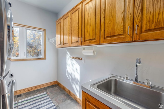 105 Paradise Rd, Summit Park, UT 84098 - laundry area with cabinet space, baseboards, stacked washer and clothes dryer, and stone finish flooring