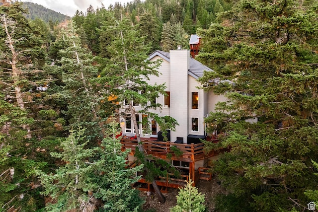 105 Paradise Rd, Summit Park, UT 84098 - view of side of property with a chimney, a view of trees, and a wooden deck