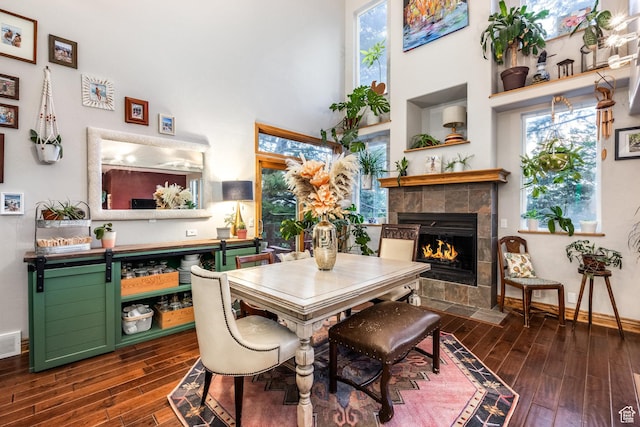 105 Paradise Rd, Summit Park, UT 84098 - dining space featuring dark wood-style flooring, a high ceiling, a fireplace, and baseboards