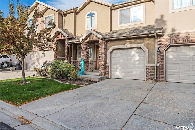 1758 W 5025 S, Roy, UT 84067 - view of property featuring stucco siding, driveway, stone siding, and a garage