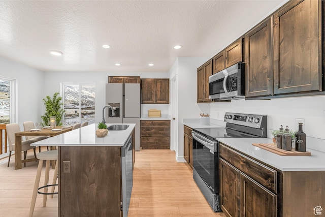 2003 S Freestone Blvd Unit 424, Santaquin, UT 84655 - kitchen with stainless steel appliances, healthy amount of natural light, a breakfast bar, light countertops, and recessed lighting