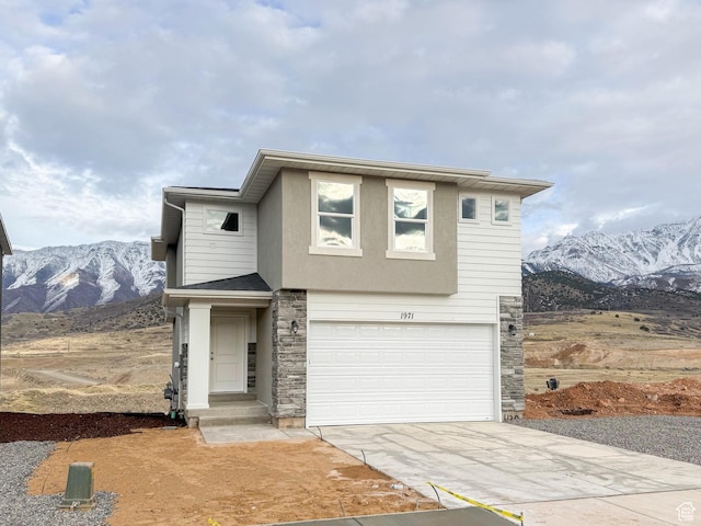 2003 S Freestone Blvd Unit 424, Santaquin, UT 84655 - view of front of home with stone siding, concrete driveway, an attached garage, and a mountain view