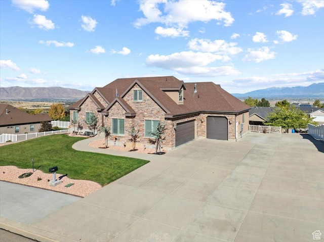 51 E Magellan Ln, Elk Ridge, UT 84651 - view of front of property featuring stone siding, a mountain view, concrete driveway, and a garage
