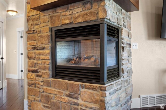 51 E Magellan Ln, Elk Ridge, UT 84651 - detailed view of ornamental molding, wood finished floors, a stone fireplace, and baseboards