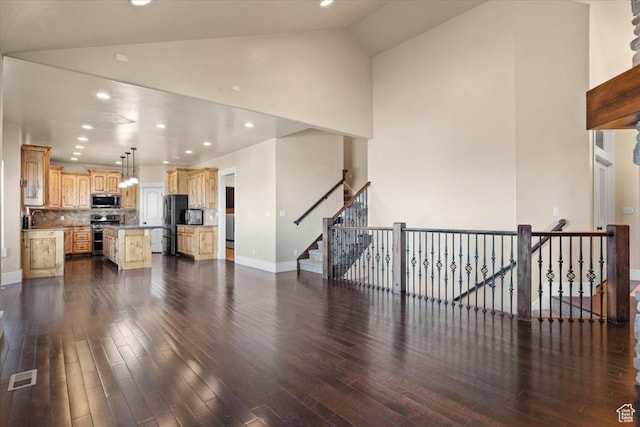 51 E Magellan Ln, Elk Ridge, UT 84651 - unfurnished living room featuring dark wood-style floors, high vaulted ceiling, baseboards, a sink, and recessed lighting