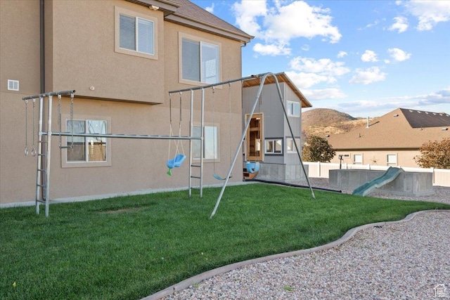 51 E Magellan Ln, Elk Ridge, UT 84651 - back of house featuring a playground and stucco siding