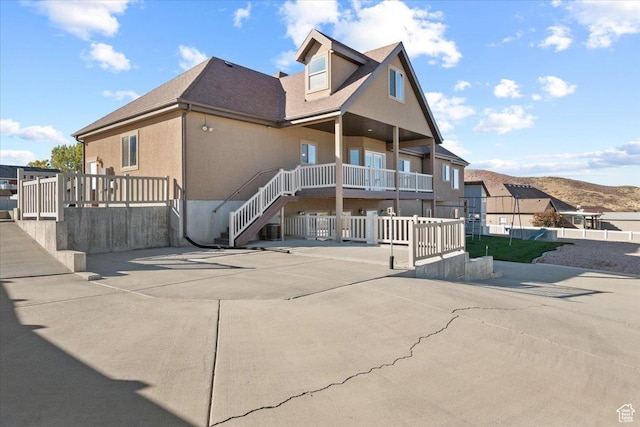 51 E Magellan Ln, Elk Ridge, UT 84651 - view of front of home with stucco siding, a porch, stairs, and roof with shingles