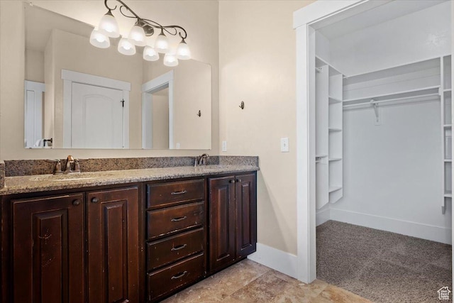 51 E Magellan Ln, Elk Ridge, UT 84651 - bathroom featuring double vanity, a spacious closet, and baseboards