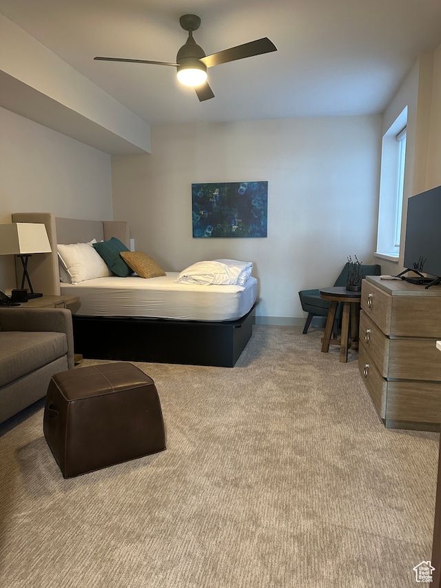 bedroom featuring light carpet and ceiling fan