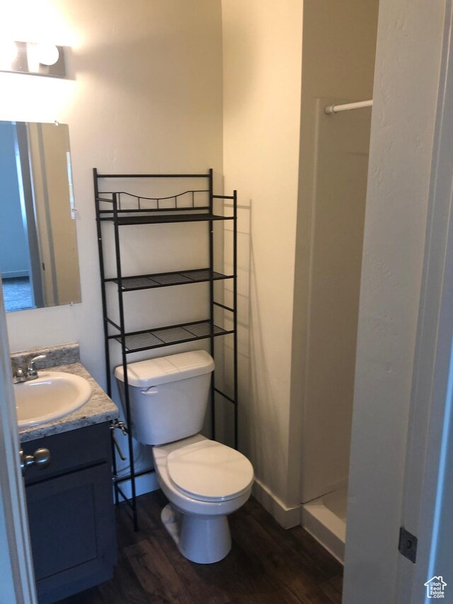 643 N 30 E, Vineyard, UT 84058 - bathroom featuring wood finished floors, toilet, vanity, baseboards, and a shower