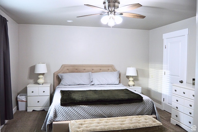 bedroom with dark colored carpet, a ceiling fan, and baseboards