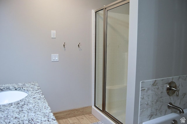full bath featuring a sink and tiled shower
