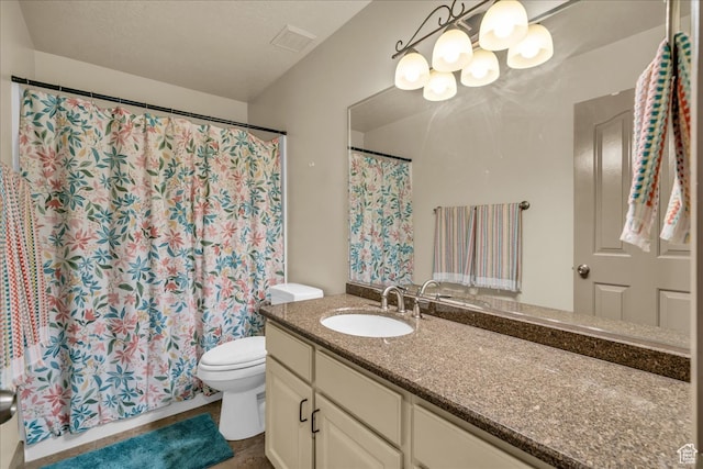 bathroom with vanity, a shower with curtain, and toilet