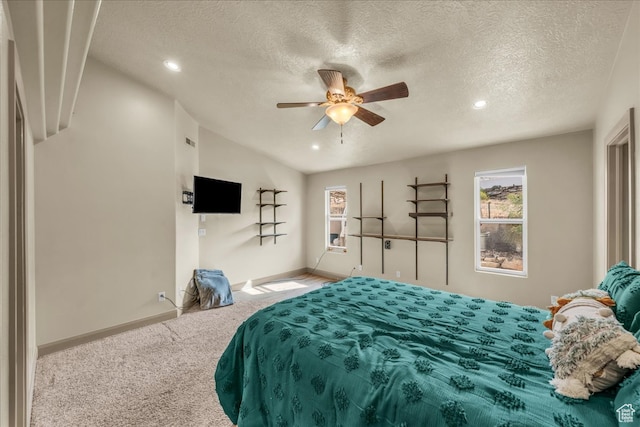carpeted bedroom featuring ceiling fan, a textured ceiling, and vaulted ceiling