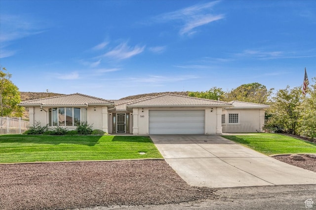 view of front of house featuring a front yard and a garage