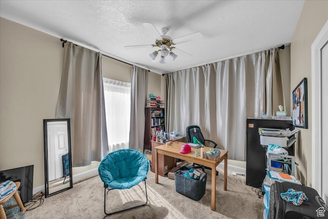 office area with light carpet, a textured ceiling, and ceiling fan