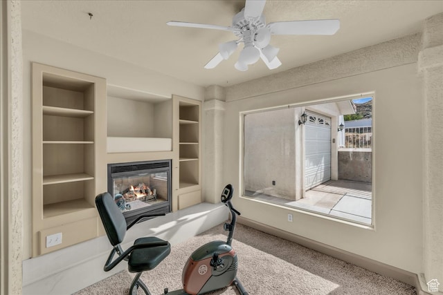 office with carpet floors, built in features, and ceiling fan