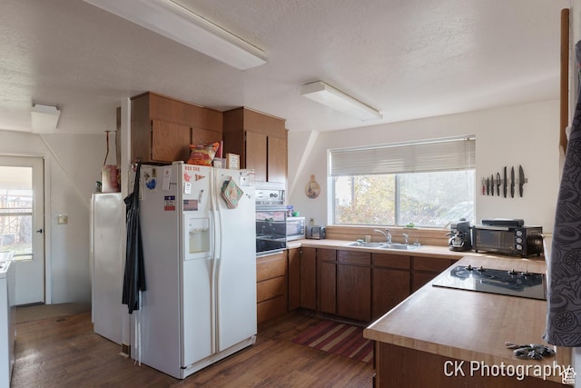 690 E 500 S, Fillmore, UT 84631 - kitchen with black appliances, a sink, dark wood-type flooring, healthy amount of natural light, and a textured ceiling