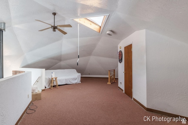 690 E 500 S, Fillmore, UT 84631 - unfurnished bedroom featuring carpet, lofted ceiling, a skylight, ceiling fan, and a textured wall