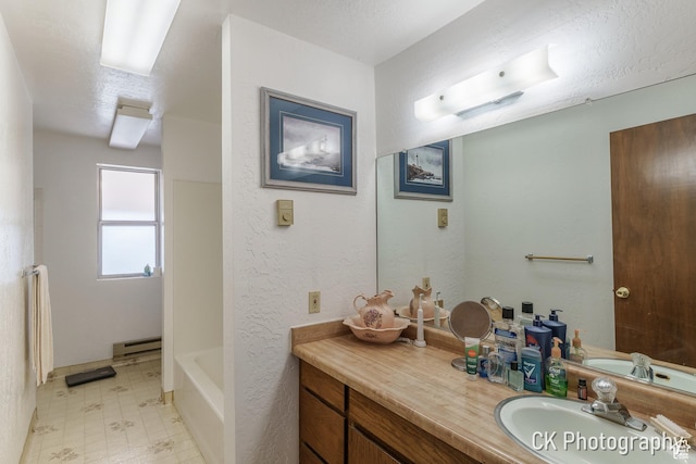 690 E 500 S, Fillmore, UT 84631 - full bath featuring baseboard heating, tile patterned floors, vanity, a tub, and a shower
