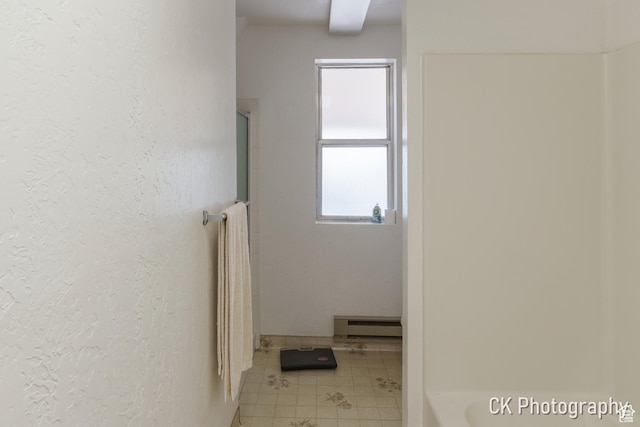 690 E 500 S, Fillmore, UT 84631 - full bath featuring baseboard heating, a shower, a tub to relax in, tile patterned floors, and a textured wall