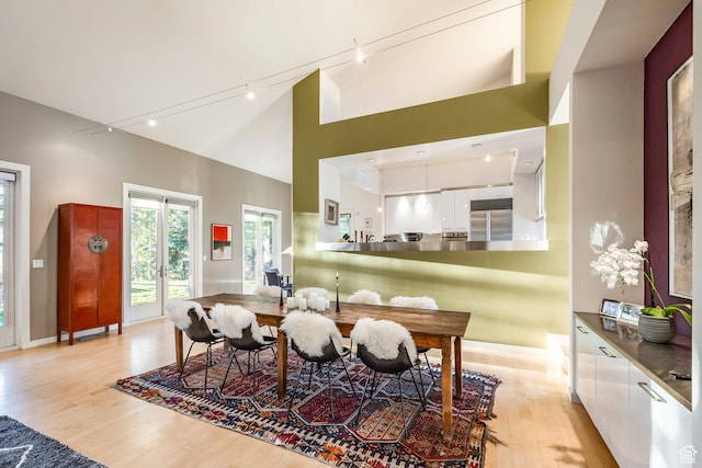 671 N Freeze Creek Cir, Emigration Canyon, UT 84108 - dining room with track lighting, light wood finished floors, baseboards, and a towering ceiling