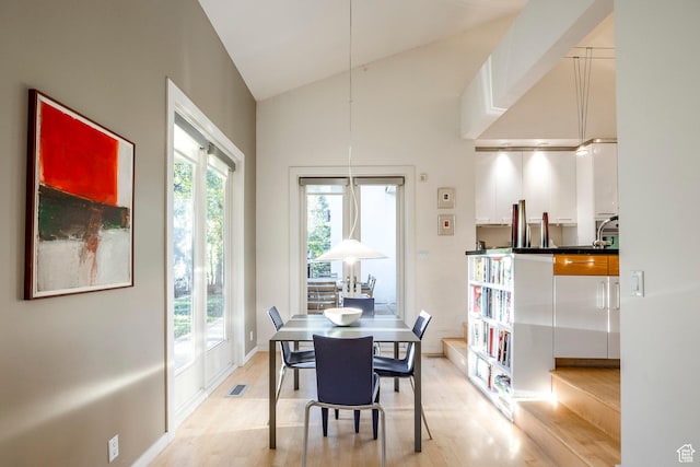 671 N Freeze Creek Cir, Emigration Canyon, UT 84108 - dining space with light wood finished floors, high vaulted ceiling, and baseboards
