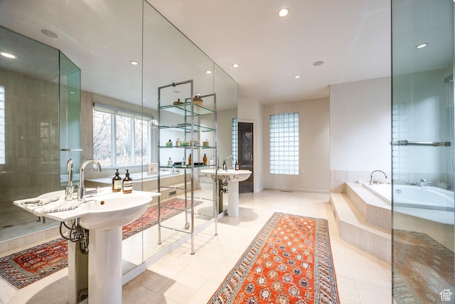 671 N Freeze Creek Cir, Emigration Canyon, UT 84108 - bathroom with plenty of natural light, tiled tub, tile patterned floors, and recessed lighting