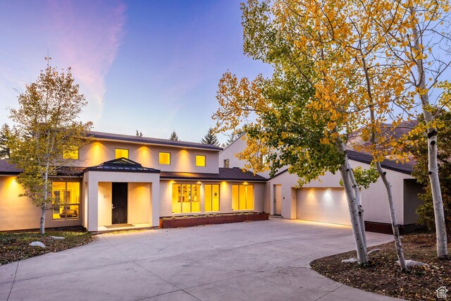 671 N Freeze Creek Cir, Emigration Canyon, UT 84108 - view of front of home with stucco siding, driveway, a garage, and a standing seam roof