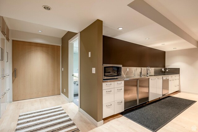 671 N Freeze Creek Cir, Emigration Canyon, UT 84108 - kitchen featuring stainless steel counters, appliances with stainless steel finishes, white cabinetry, light wood-style flooring, and a sink