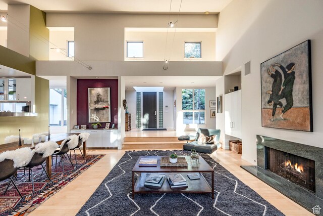 671 N Freeze Creek Cir, Emigration Canyon, UT 84108 - living room with a fireplace, a towering ceiling, and wood finished floors