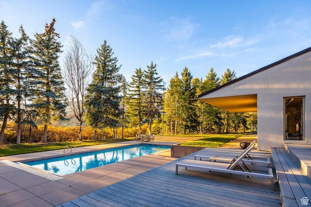 671 N Freeze Creek Cir, Emigration Canyon, UT 84108 - outdoor pool with a deck, view of wooded area, and a yard