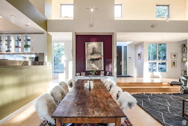 671 N Freeze Creek Cir, Emigration Canyon, UT 84108 - dining space featuring a high ceiling, plenty of natural light, wood finished floors, and baseboards