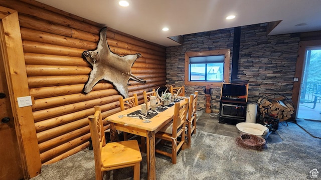 miscellaneous room with recessed lighting and a wood stove