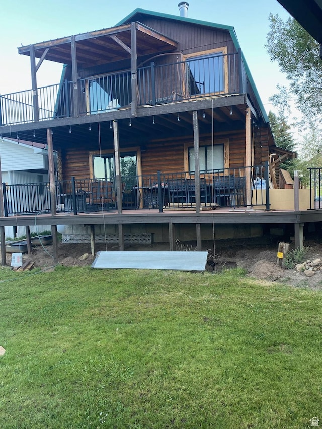 back of property featuring a lawn and a balcony