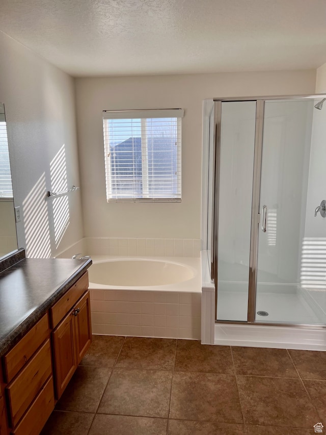 3119 N Sage Loop Unit F3, Lehi, UT 84043 - bathroom with vanity, plus walk in shower, a textured ceiling, and tile patterned floors