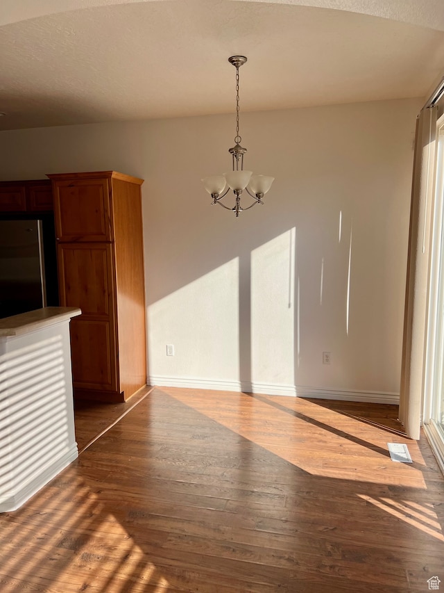 3119 N Sage Loop Unit F3, Lehi, UT 84043 - unfurnished dining area featuring a notable chandelier and hardwood / wood-style floors