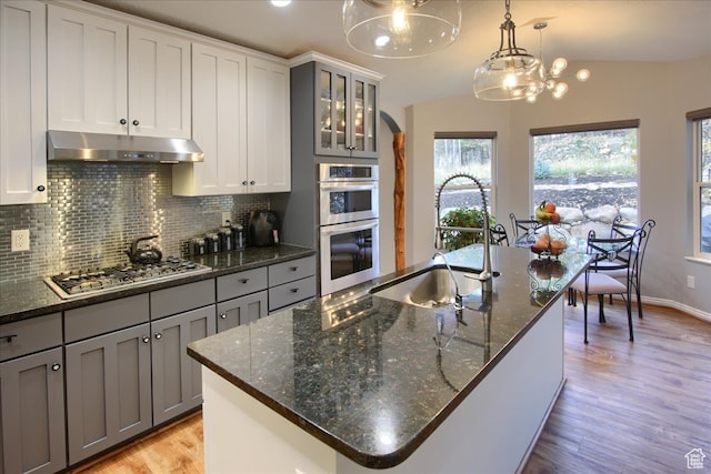 3937 N Patio Springs Dr, Eden, UT 84310 - kitchen featuring a kitchen island with sink, sink, gray cabinetry, light hardwood / wood-style floors, and decorative light fixtures