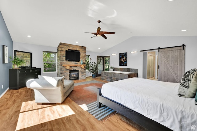 3937 N Patio Springs Dr, Eden, UT 84310 - bedroom featuring vaulted ceiling, a barn door, light wood-style floors, baseboards, and a fireplace