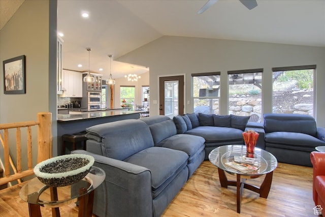 3937 N Patio Springs Dr, Eden, UT 84310 - living room featuring light hardwood / wood-style floors, lofted ceiling, a chandelier, and plenty of natural light