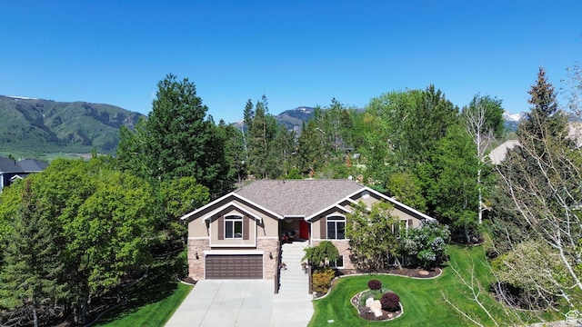 3937 N Patio Springs Dr, Eden, UT 84310 - view of front of property with a garage, a front lawn, stucco siding, driveway, and stone siding
