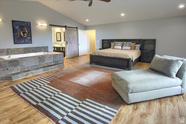 3937 N Patio Springs Dr, Eden, UT 84310 - bedroom with ensuite bathroom, a barn door, ceiling fan, lofted ceiling, and hardwood / wood-style flooring