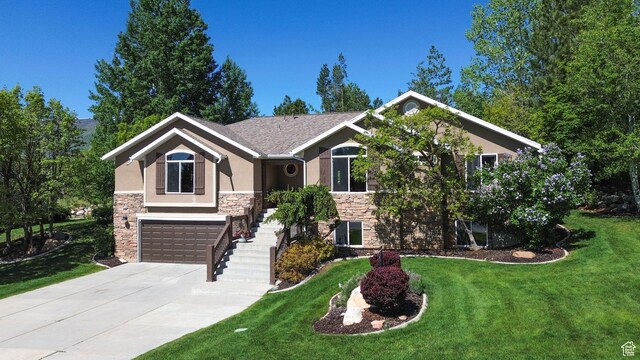 3937 N Patio Springs Dr, Eden, UT 84310 - view of front of property with stone siding, stucco siding, a front yard, driveway, and a garage