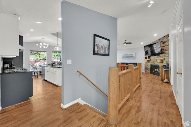 3937 N Patio Springs Dr, Eden, UT 84310 - hall featuring an upstairs landing, lofted ceiling, light wood-type flooring, baseboards, and a chandelier