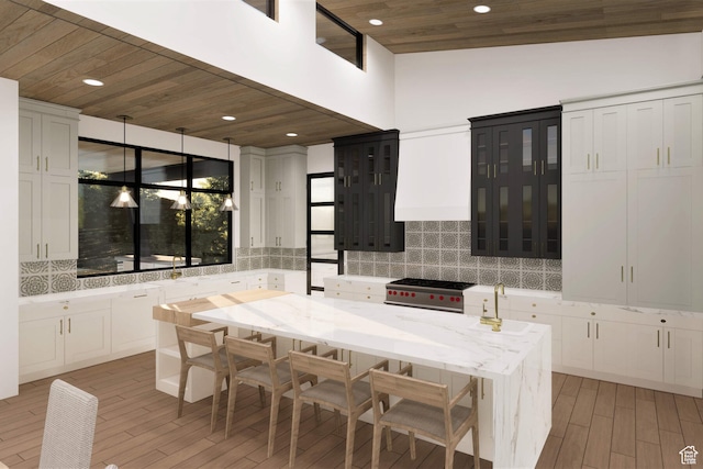 2121 E Flat Top Mountain Dr Unit 727, Heber City, UT 84032 - kitchen with lofted ceiling, stainless steel gas stove, light stone countertops, pendant lighting, and tasteful backsplash
