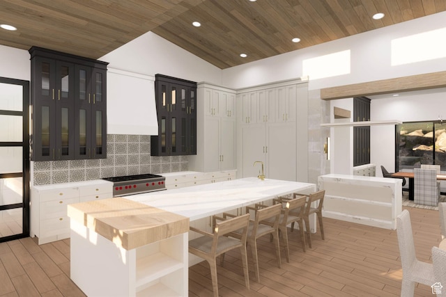 2121 E Flat Top Mountain Dr Unit 727, Heber City, UT 84032 - kitchen featuring white cabinetry, light hardwood / wood-style floors, lofted ceiling, stainless steel range, and decorative backsplash