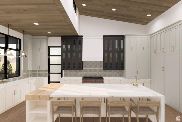 2121 E Flat Top Mountain Dr Unit 727, Heber City, UT 84032 - kitchen with lofted ceiling, white cabinets, decorative backsplash, wood-type flooring, and stainless steel range oven