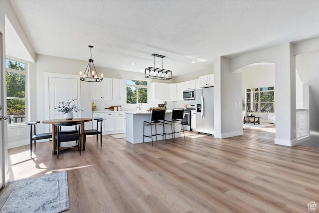 13133 S Crystal Springs Dr, Draper, UT 84020 - kitchen featuring appliances with stainless steel finishes, healthy amount of natural light, white cabinetry, a textured ceiling, and recessed lighting