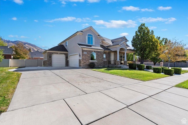 13133 S Crystal Springs Dr, Draper, UT 84020 - view of front of house with stone siding, driveway, covered porch, and a garage